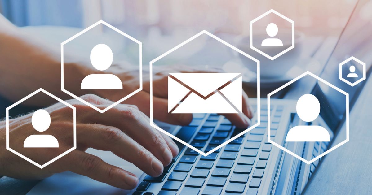 A hand on a keyboard sending an email